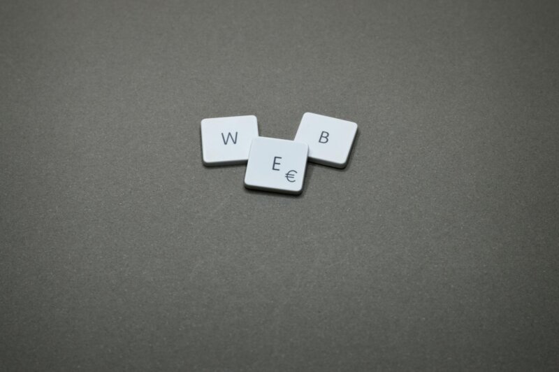 Minimalist image of keyboard keys spelling 'WEB' on a plain background.
